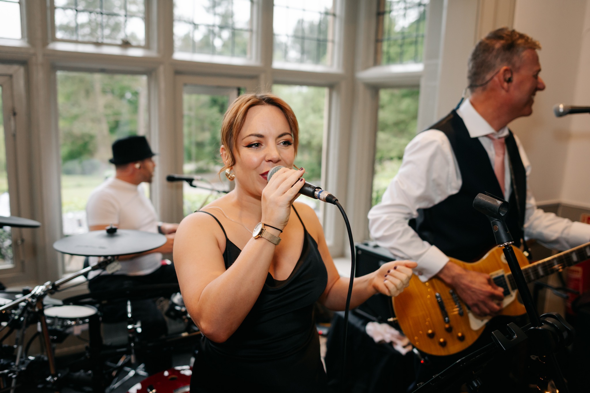 Vocalist and guitarist performing together at a wedding reception